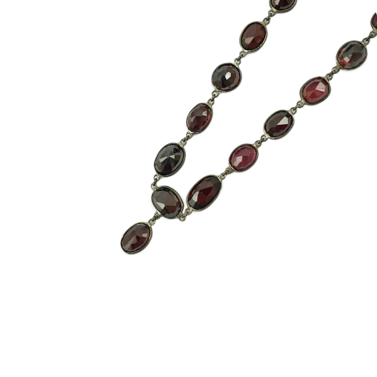 A Victorian silver and graduated oval cut two colour garnet set drop spectacle necklace